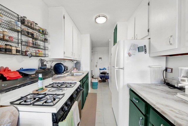 290 W 232nd St Unit 8E, Bronx, NY 10463 - kitchen featuring white appliances, light tile patterned floors, white cabinets, and light countertops