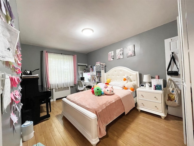 252-23 63rd Ave Unit 1081, Little Neck, NY 11362 - bedroom featuring radiator heating unit and light wood-style floors