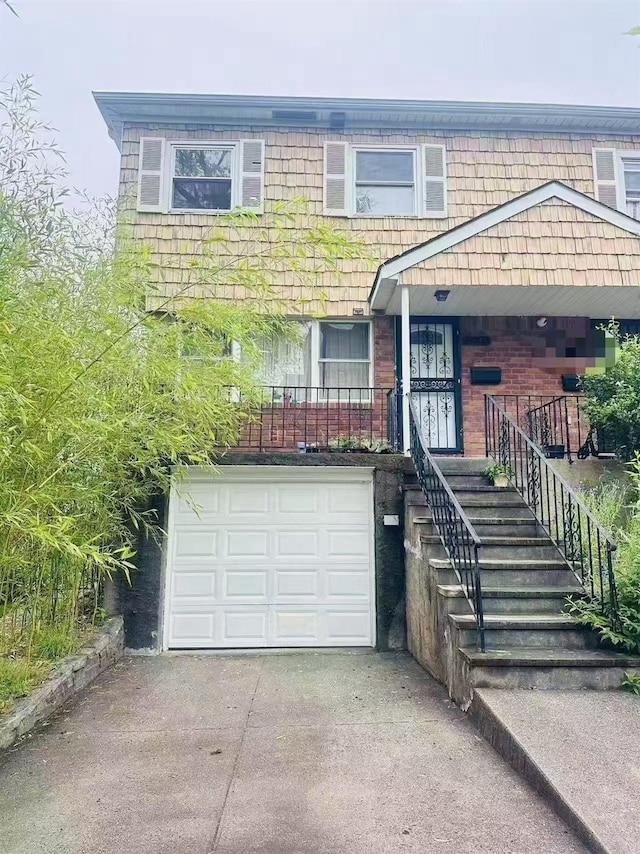 141-31 25th Rd, Flushing, NY 11354 - view of front of property featuring driveway and an attached garage