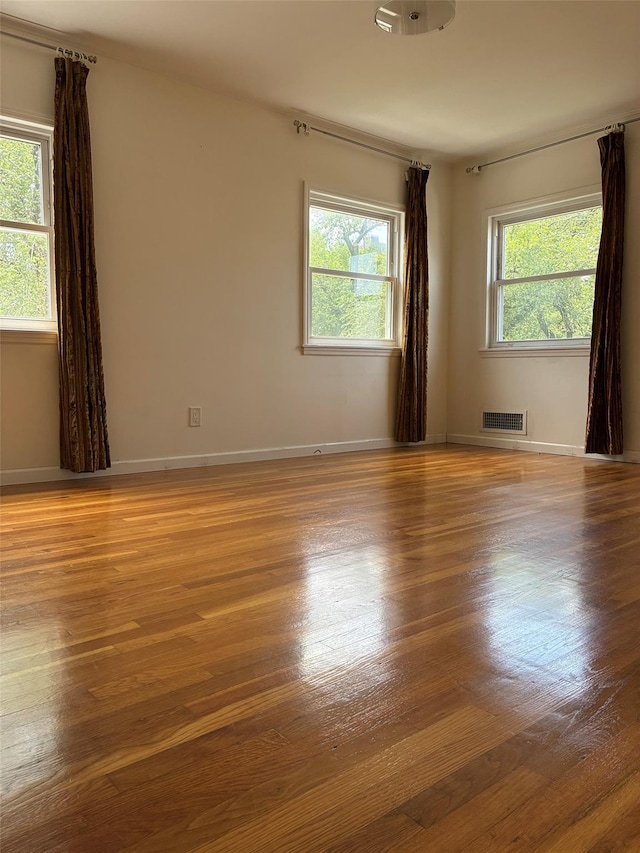 141-31 25th Rd, Flushing, NY 11354 - empty room featuring plenty of natural light and wood finished floors