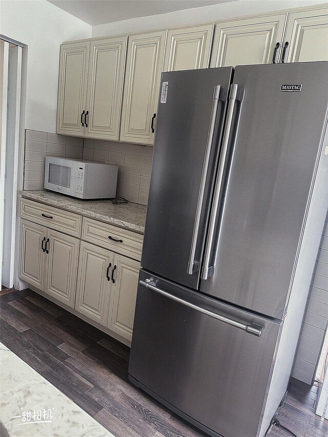 141-31 25th Rd, Flushing, NY 11354 - kitchen featuring high end fridge, white microwave, dark wood-type flooring, cream cabinets, and tasteful backsplash