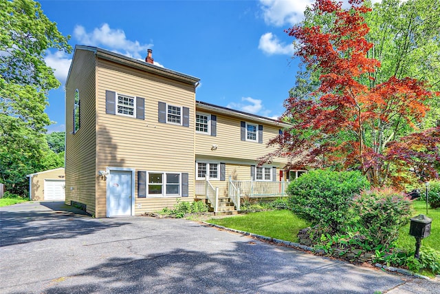89 Circuit Rd, Bellport, NY 11713 - view of front facade featuring a chimney and a detached garage