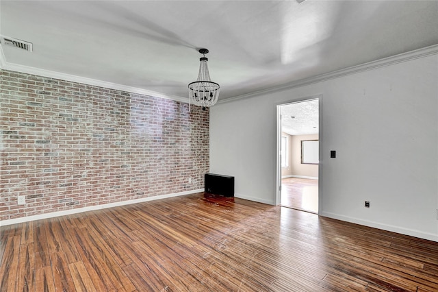 89 Circuit Rd, Bellport, NY 11713 - unfurnished room with a chandelier, wood finished floors, brick wall, and ornamental molding