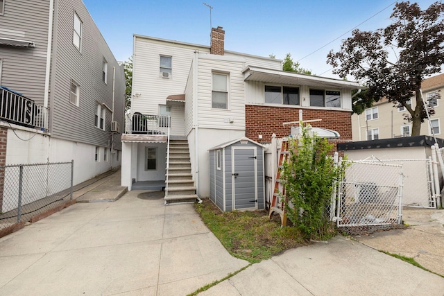 3046 Coddington Ave, Bronx, NY 10461 - back of house with a storage unit, a gate, stairs, and a chimney