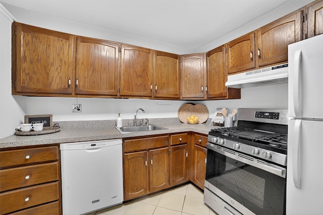 13 Scenic Unit J, Croton-On-Hudson, NY 10520 - kitchen with white appliances, under cabinet range hood, light tile patterned floors, and brown cabinets