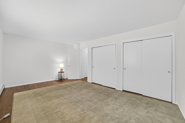 13 Scenic Unit J, Croton-On-Hudson, NY 10520 - unfurnished bedroom featuring two closets and wood finished floors