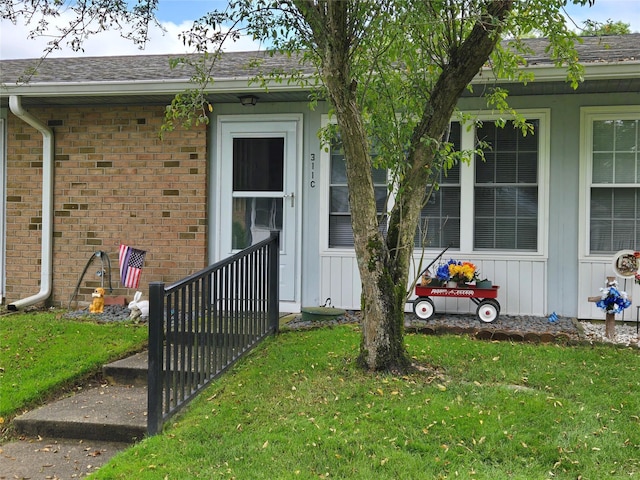 311 Woodbridge Dr Unit 311-C, Ridge, NY 11961 - property entrance featuring a lawn and brick siding