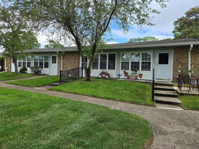 311 Woodbridge Dr Unit 311-C, Ridge, NY 11961 - ranch-style house with brick siding and a front lawn