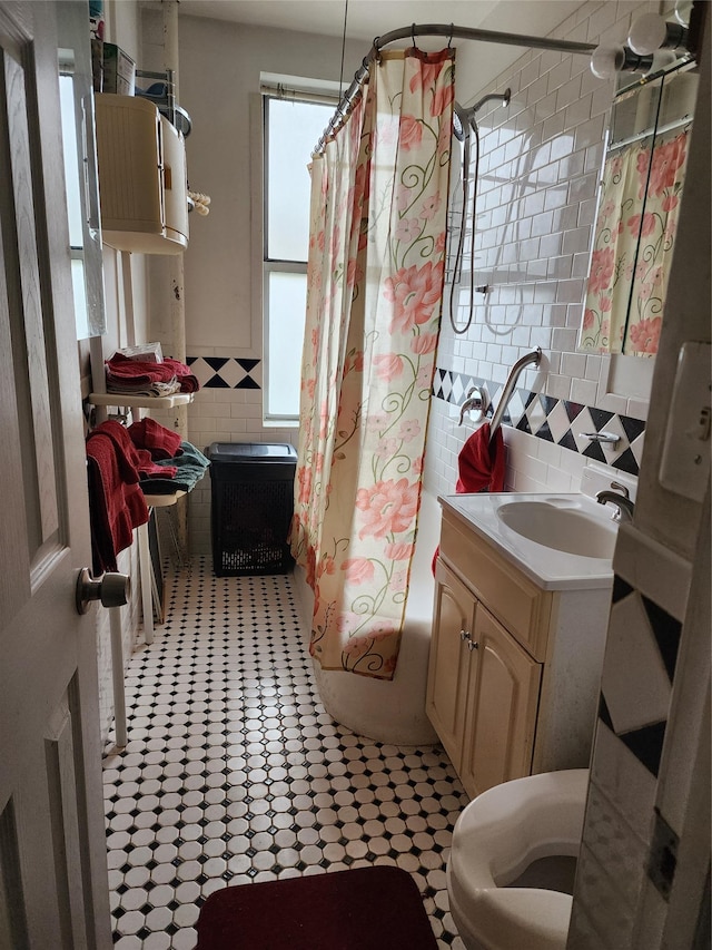 472 Gramatan Ave Unit X3, Mount Vernon, NY 10552 - bathroom featuring tile walls, shower / bath combo with shower curtain, vanity, and tile patterned flooring