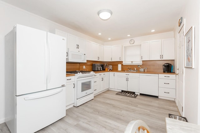 8 Division Ave, East Islip, NY 11730 - kitchen featuring white appliances, white cabinets, tasteful backsplash, light wood-style flooring, and recessed lighting