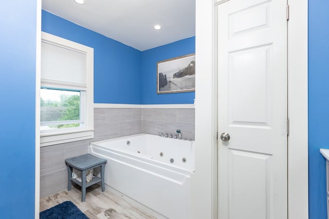 8 Division Ave, East Islip, NY 11730 - full bath with tile walls, a tub with jets, wood finished floors, and recessed lighting