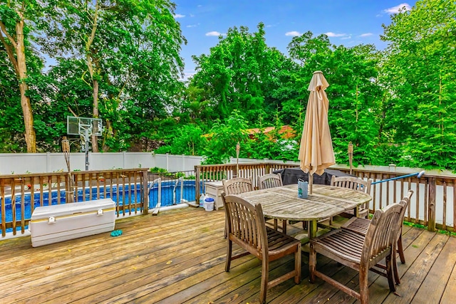 8 Division Ave, East Islip, NY 11730 - wooden terrace featuring outdoor dining space, view of scattered trees, and a fenced backyard