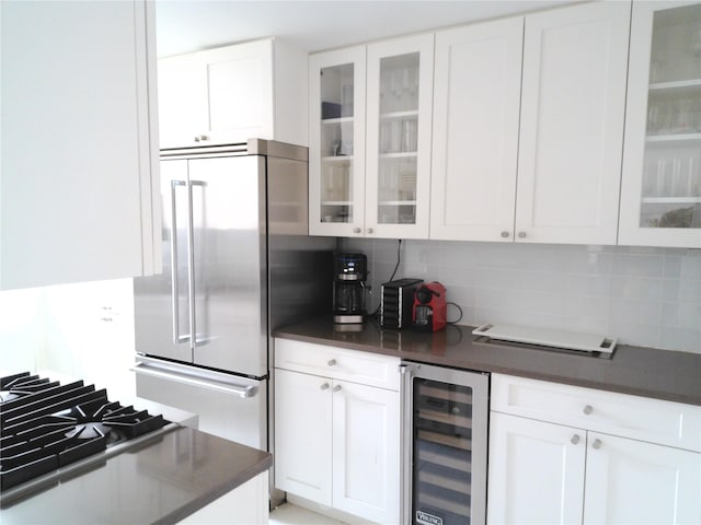 200 E 66th St Unit B1503, New York Manhattan, NY 10065 - kitchen with beverage cooler, dark countertops, decorative backsplash, and white cabinetry