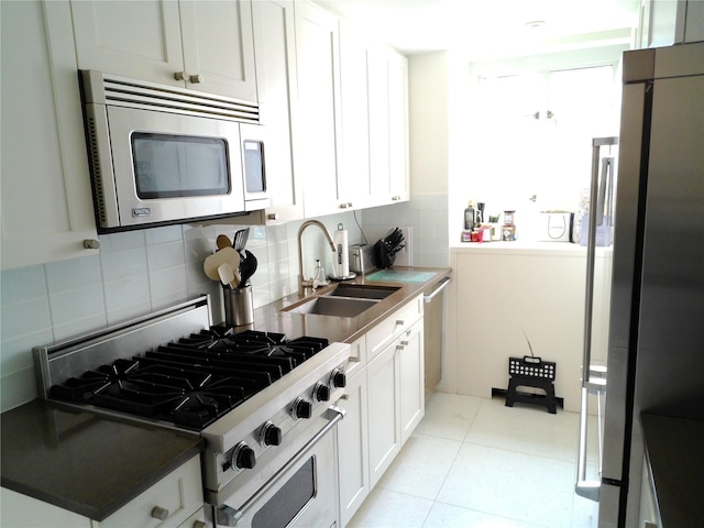200 E 66th St Unit B1503, New York Manhattan, NY 10065 - kitchen featuring appliances with stainless steel finishes, decorative backsplash, and white cabinets