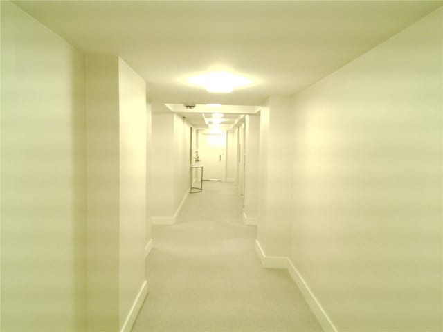 200 E 66th St Unit B1503, New York Manhattan, NY 10065 - hallway with baseboards and light carpet