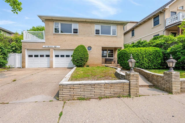 615 E Olive St, Long Beach, NY 11561 - view of front of home with brick siding, driveway, an attached garage, and a balcony