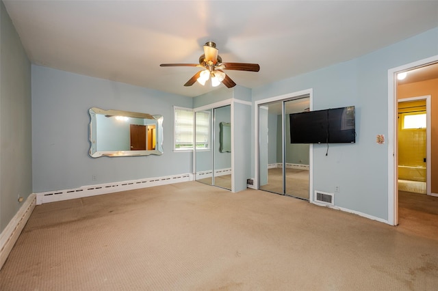 615 E Olive St, Long Beach, NY 11561 - unfurnished bedroom featuring carpet floors, two closets, multiple windows, and baseboard heating