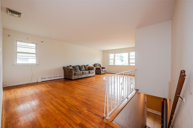 615 E Olive St, Long Beach, NY 11561 - living room featuring a baseboard heating unit, hardwood / wood-style flooring, and baseboard heating
