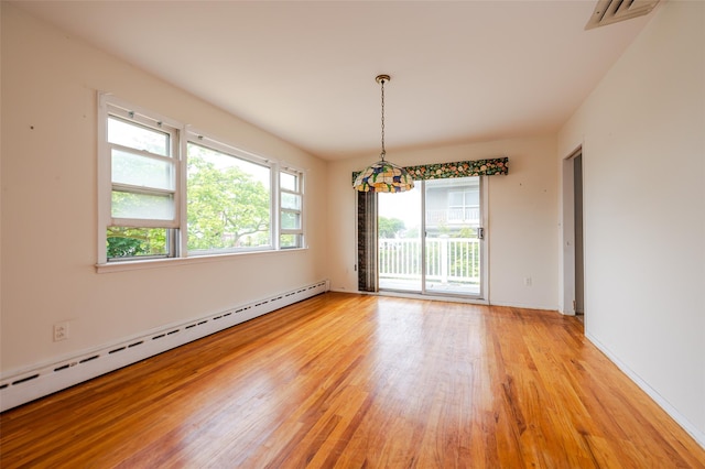 615 E Olive St, Long Beach, NY 11561 - spare room featuring a baseboard radiator and light wood-type flooring