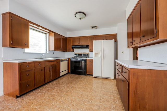 615 E Olive St, Long Beach, NY 11561 - kitchen with white fridge with ice dispenser, dishwashing machine, range with gas stovetop, under cabinet range hood, and light countertops
