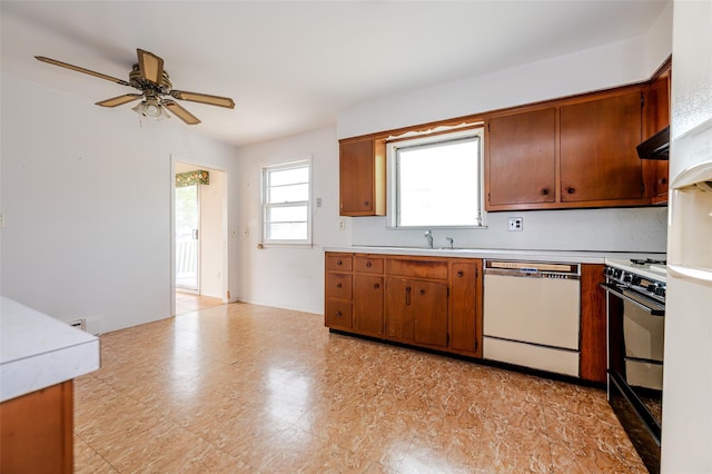 615 E Olive St, Long Beach, NY 11561 - kitchen with dishwasher, gas range oven, a ceiling fan, light countertops, and under cabinet range hood