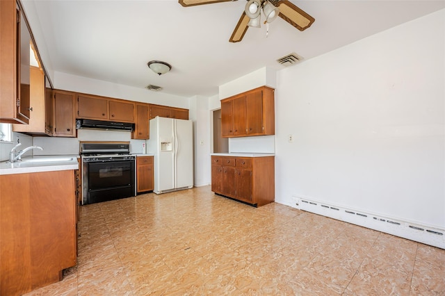 615 E Olive St, Long Beach, NY 11561 - kitchen with white fridge with ice dispenser, range with gas cooktop, baseboard heating, and brown cabinetry