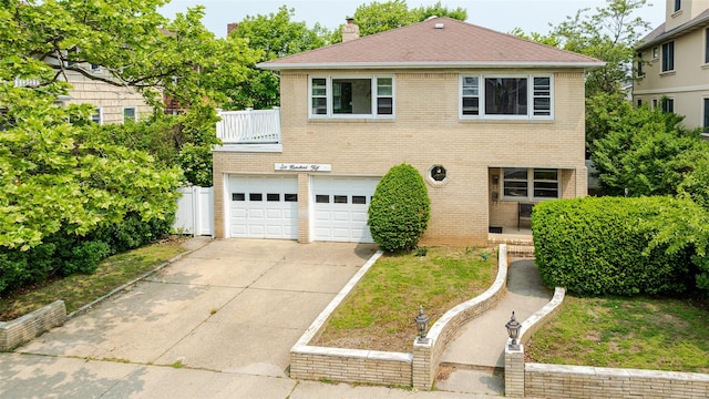 615 E Olive St, Long Beach, NY 11561 - view of front of property featuring driveway, brick siding, a garage, and a chimney