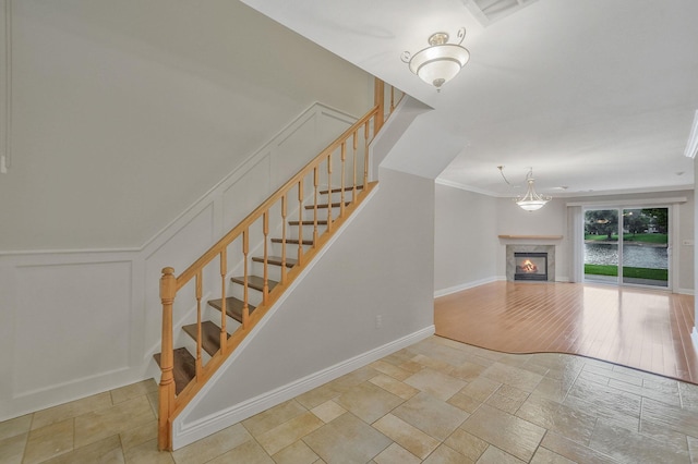 86 Erik Dr, East Setauket, NY 11733 - stairway with a glass covered fireplace, stone finish floors, and a decorative wall