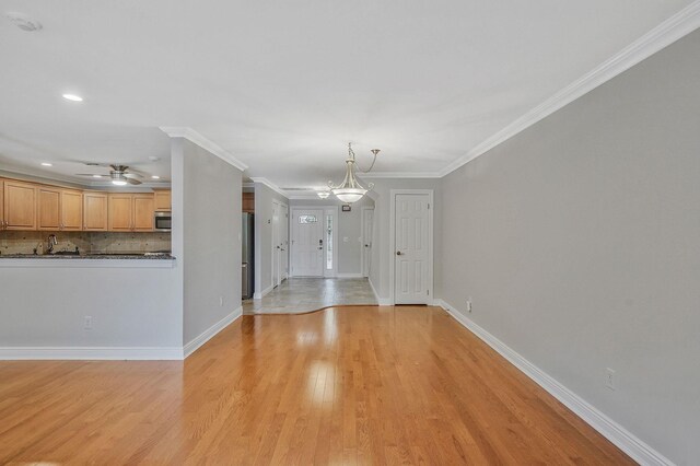 86 Erik Dr, East Setauket, NY 11733 - unfurnished living room with light wood-style floors, a ceiling fan, ornamental molding, and recessed lighting