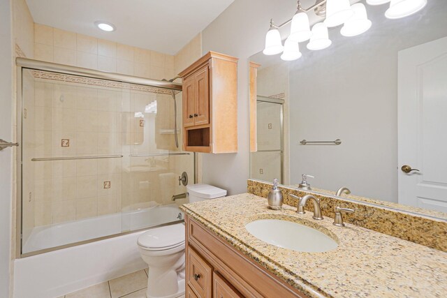 86 Erik Dr, East Setauket, NY 11733 - bathroom featuring vanity, tile patterned flooring, and combined bath / shower with glass door