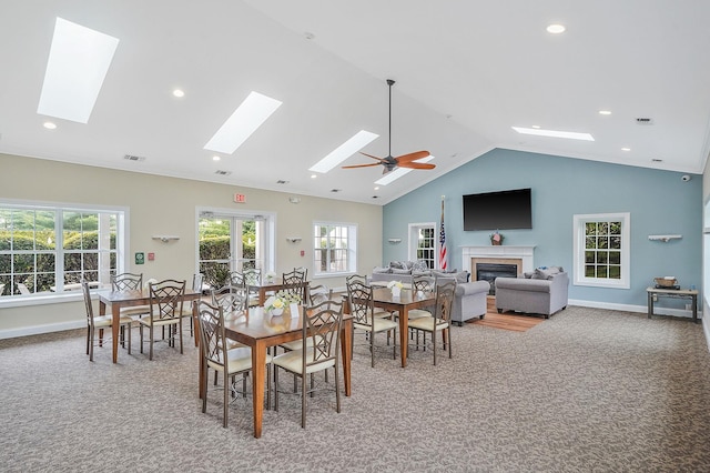 86 Erik Dr, East Setauket, NY 11733 - dining room with a skylight, a glass covered fireplace, light colored carpet, healthy amount of natural light, and recessed lighting