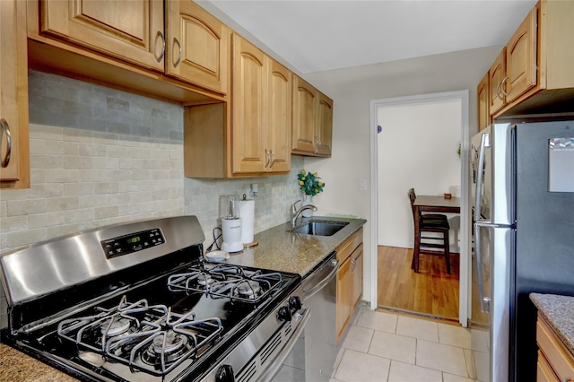 25 Elizabeth St Unit 1P, Farmingdale, NY 11735 - kitchen featuring appliances with stainless steel finishes, light tile patterned floors, tasteful backsplash, and dark stone countertops