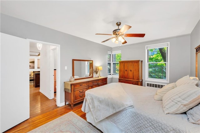 9707 4th Ave Unit 3R, Brooklyn, NY 11209 - bedroom featuring radiator heating unit, light wood-style flooring, and ceiling fan