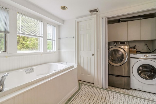 140 Old Farm Rd S, Pleasantville, NY 10570 - full bath with washer and dryer, a jetted tub, wainscoting, and tile patterned floors