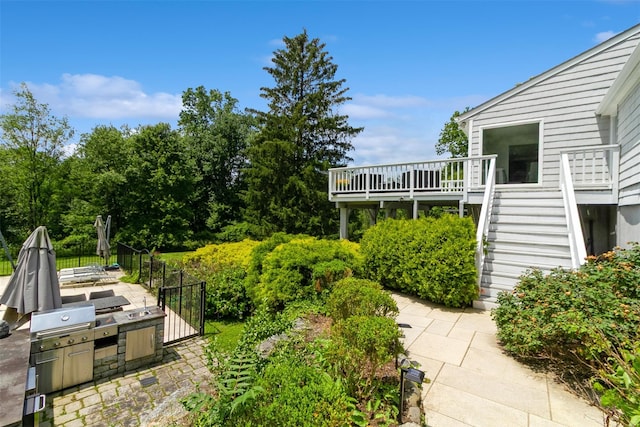 140 Old Farm Rd S, Pleasantville, NY 10570 - view of yard with stairs, a wooden deck, a patio area, and an outdoor kitchen