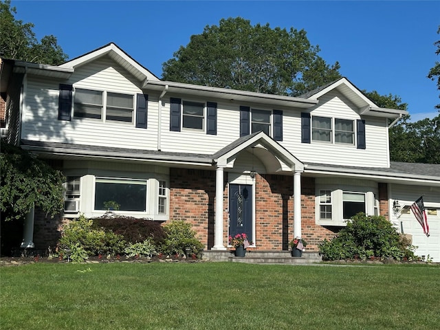 113 Pine St, Port Jefferson Station, NY 11776 - view of front facade featuring brick siding, a front lawn, and a garage