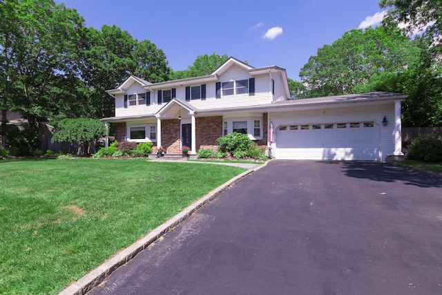113 Pine St, Port Jefferson Station, NY 11776 - view of front of home with an attached garage, driveway, and a front yard