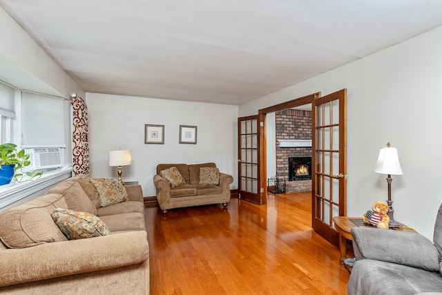 113 Pine St, Port Jefferson Station, NY 11776 - living room with wood finished floors, a fireplace, and cooling unit