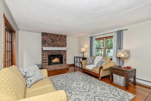 113 Pine St, Port Jefferson Station, NY 11776 - living area with wood finished floors, crown molding, a fireplace, and a baseboard radiator