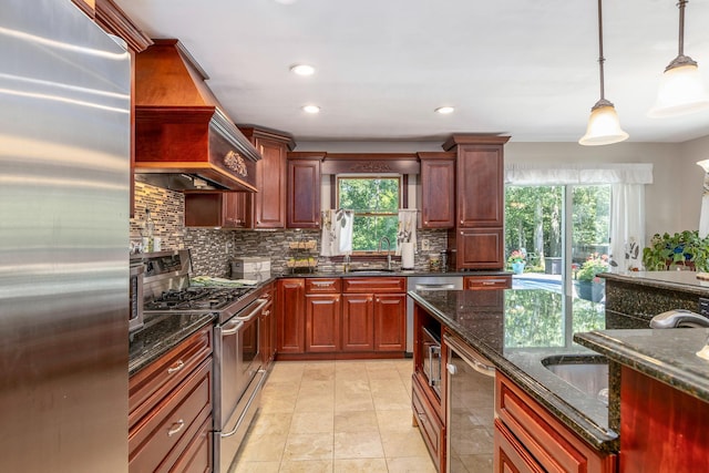 113 Pine St, Port Jefferson Station, NY 11776 - kitchen with stainless steel appliances, tasteful backsplash, custom exhaust hood, pendant lighting, and dark stone counters