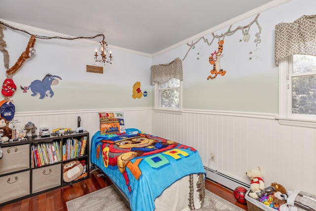 113 Pine St, Port Jefferson Station, NY 11776 - bedroom featuring wainscoting, wood finished floors, a chandelier, baseboard heating, and crown molding