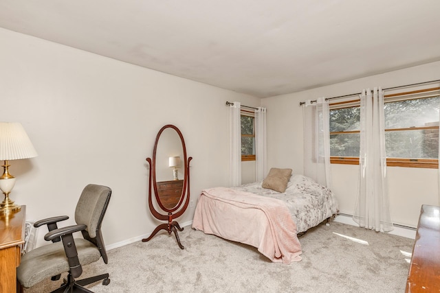 113 Pine St, Port Jefferson Station, NY 11776 - carpeted bedroom featuring a baseboard heating unit and a desk