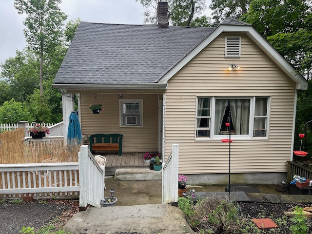 126 Tanglewylde Rd, Lake Peekskill, NY 10579 - bungalow-style home featuring a shingled roof, a chimney, and covered porch