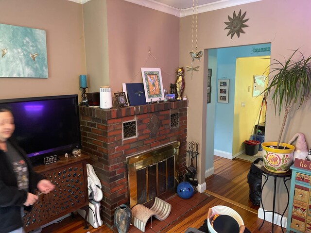 126 Tanglewylde Rd, Lake Peekskill, NY 10579 - living area featuring wood finished floors, crown molding, and a fireplace