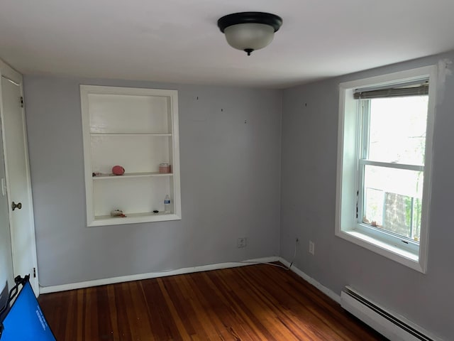 126 Tanglewylde Rd, Lake Peekskill, NY 10579 - spare room featuring a baseboard radiator, healthy amount of natural light, and wood finished floors