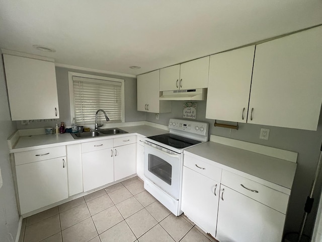 126 Tanglewylde Rd, Lake Peekskill, NY 10579 - kitchen with white electric range oven, under cabinet range hood, light tile patterned floors, light countertops, and white cabinetry