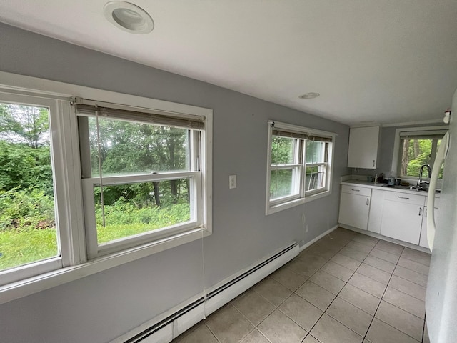 126 Tanglewylde Rd, Lake Peekskill, NY 10579 - kitchen with light tile patterned floors, a baseboard radiator, white cabinetry, and light countertops