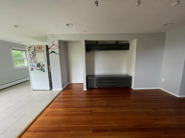 126 Tanglewylde Rd, Lake Peekskill, NY 10579 - unfurnished living room with wood finished floors, recessed lighting, and a baseboard heating unit