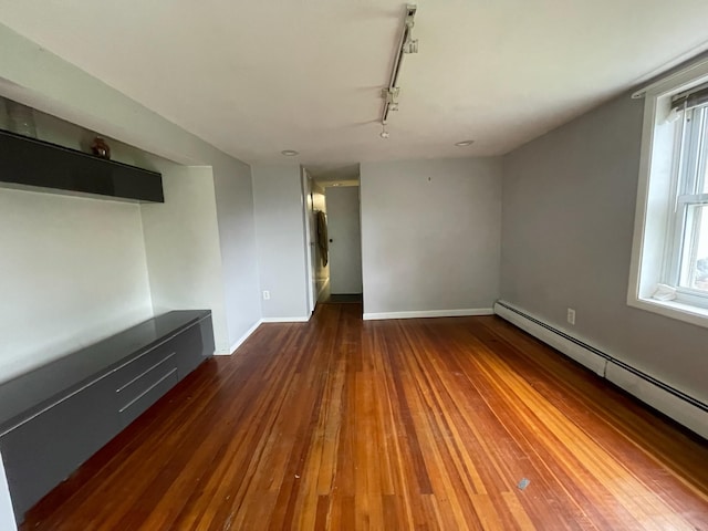 126 Tanglewylde Rd, Lake Peekskill, NY 10579 - spare room with a baseboard heating unit, track lighting, hardwood / wood-style flooring, and plenty of natural light