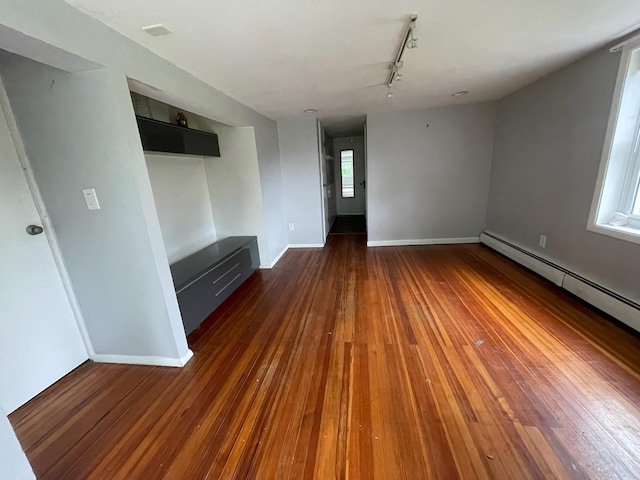 126 Tanglewylde Rd, Lake Peekskill, NY 10579 - unfurnished living room with track lighting, hardwood / wood-style floors, and a baseboard radiator